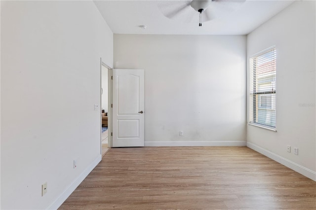 empty room featuring light wood-type flooring and ceiling fan