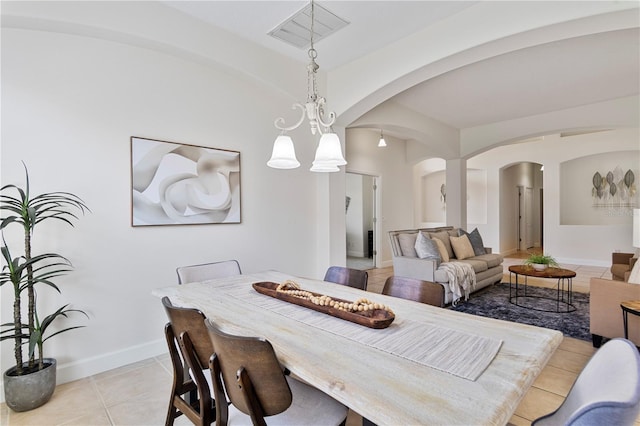 dining space featuring a chandelier and light tile patterned flooring