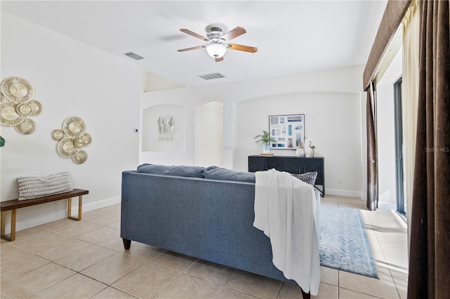 tiled living room with ceiling fan