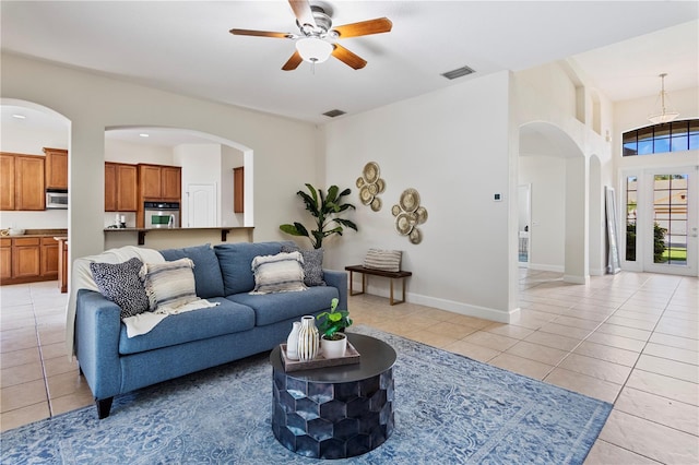 tiled living room featuring ceiling fan