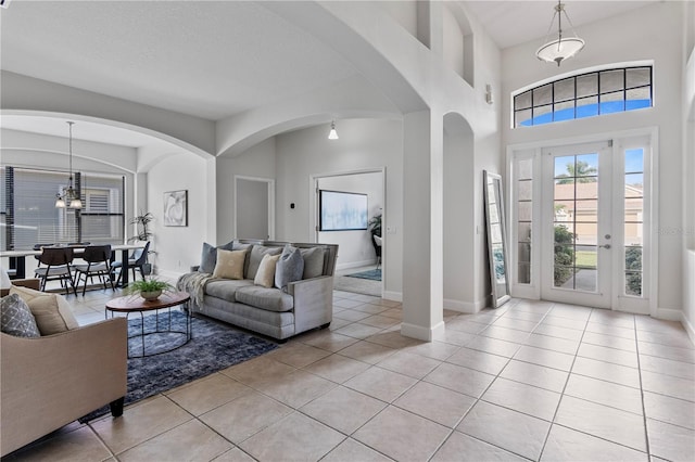 living room featuring a notable chandelier and light tile patterned floors