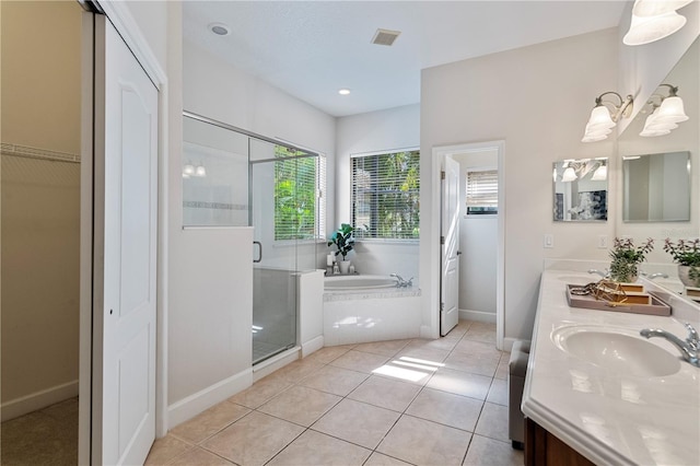 bathroom with tile patterned floors, shower with separate bathtub, and vanity