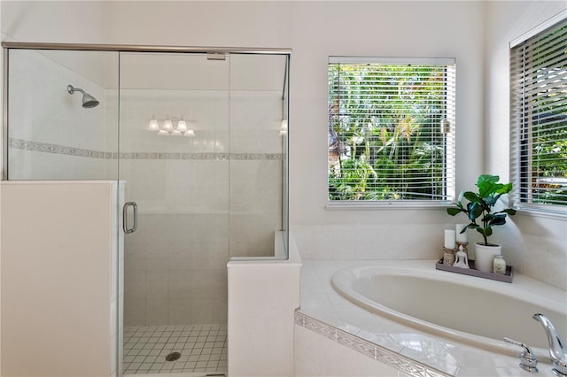 bathroom with shower with separate bathtub