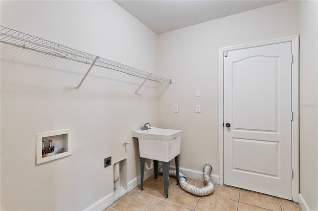 washroom with light tile patterned floors, electric dryer hookup, washer hookup, and a textured ceiling