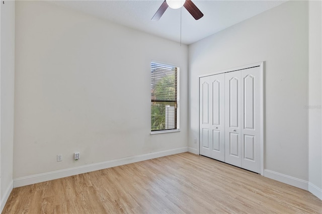 unfurnished bedroom with light hardwood / wood-style flooring, ceiling fan, and a closet