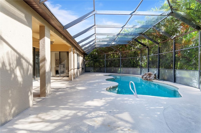 view of swimming pool featuring a lanai and a patio area