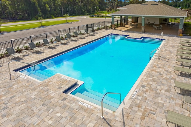 view of swimming pool featuring a patio area