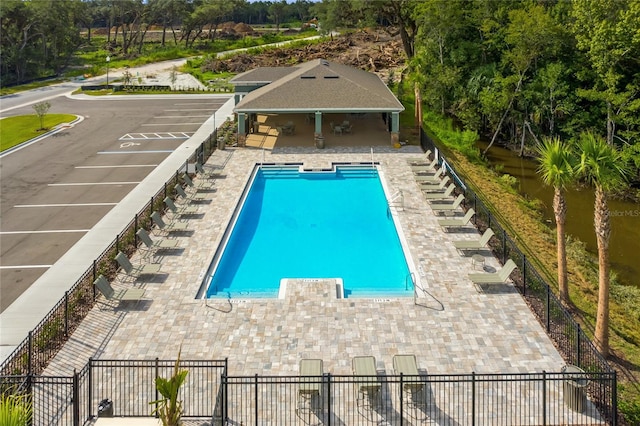 view of pool featuring a patio area and an outbuilding