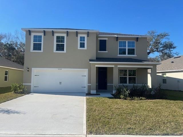 view of front of house with a front lawn and a garage