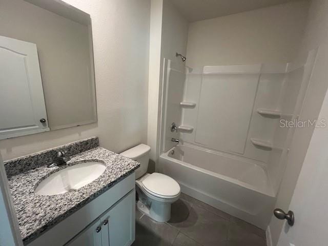 full bathroom featuring toilet, vanity, tub / shower combination, and tile patterned floors