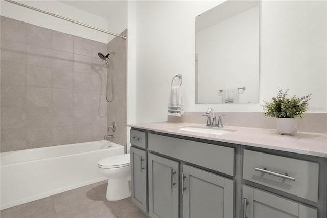 full bathroom with tile patterned floors, vanity, tiled shower / bath combo, and toilet