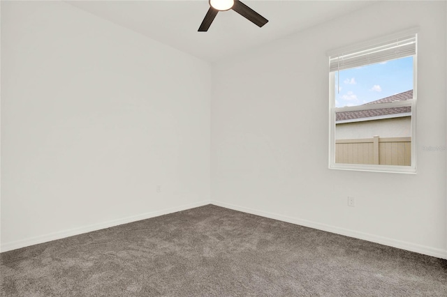 carpeted spare room with ceiling fan