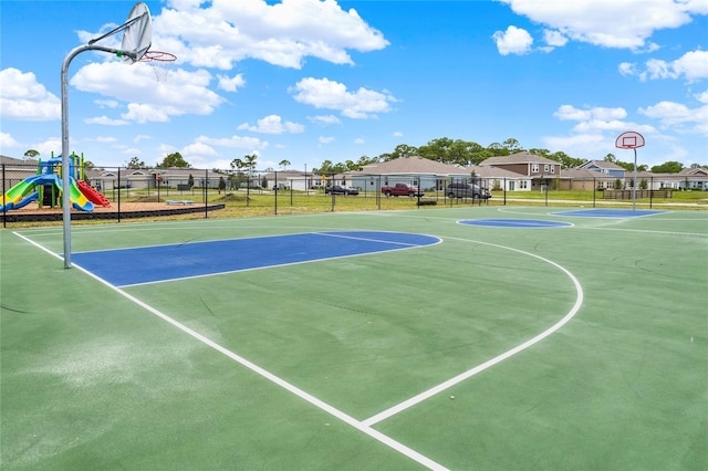 view of basketball court with a playground