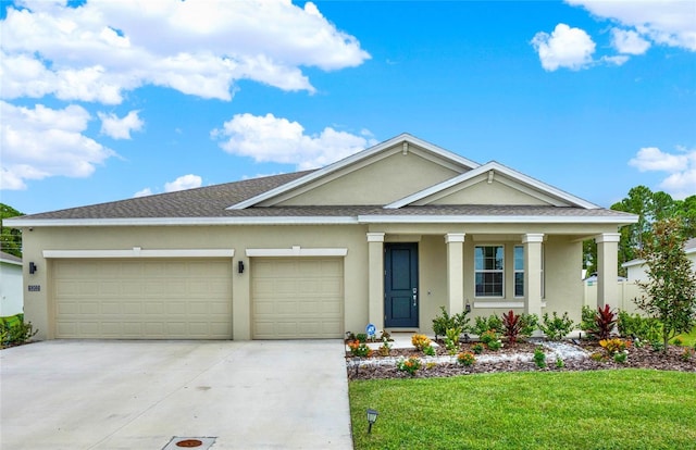 view of front of property featuring a front lawn, covered porch, and a garage