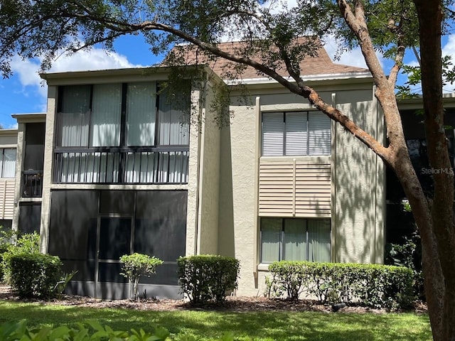 rear view of property featuring a balcony