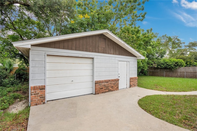 garage with a yard and wood walls