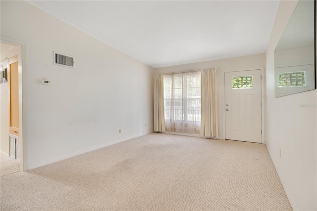 unfurnished living room featuring light colored carpet