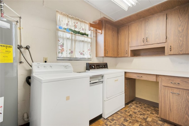 washroom featuring electric water heater, separate washer and dryer, cabinets, and dark parquet floors