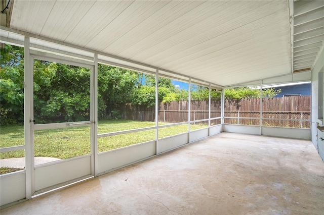 unfurnished sunroom featuring lofted ceiling