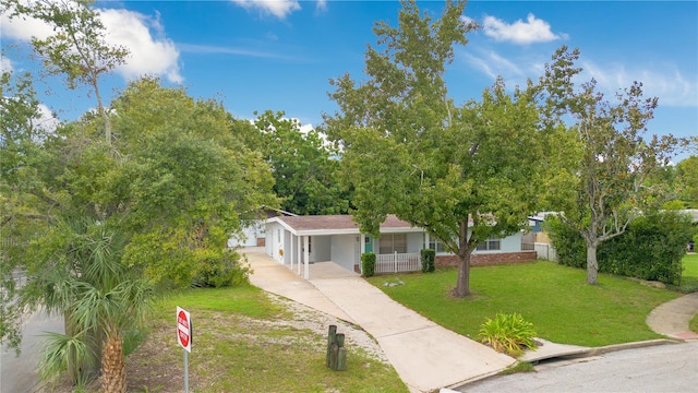 view of front of house with covered porch, a front yard, and a garage