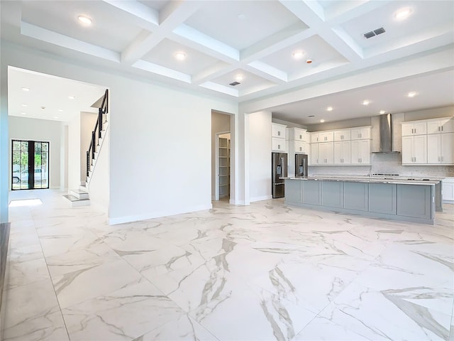 unfurnished living room featuring beamed ceiling and coffered ceiling