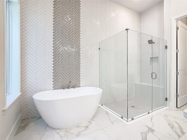 bathroom featuring separate shower and tub