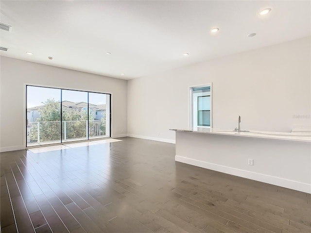 empty room with dark hardwood / wood-style flooring