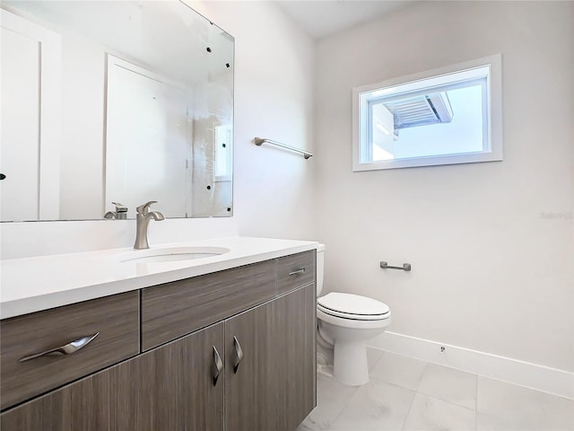 bathroom with vanity, toilet, and tile patterned floors