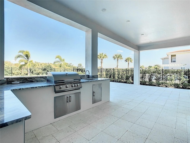 view of patio / terrace with sink, a grill, and exterior kitchen