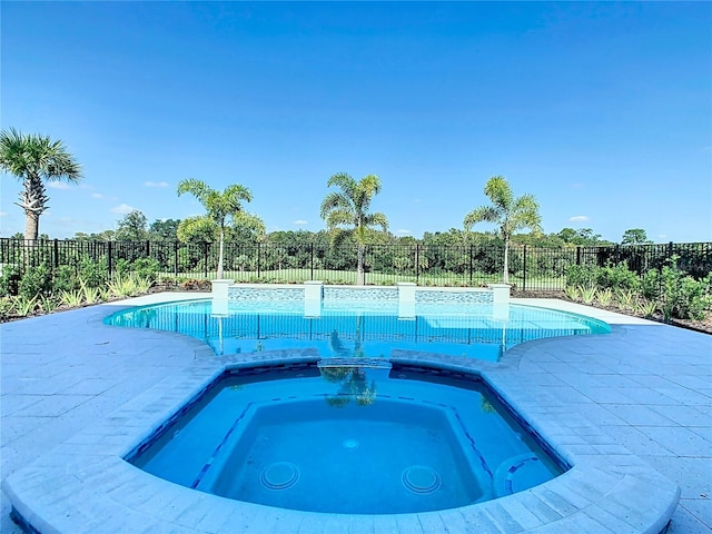 view of swimming pool featuring an in ground hot tub