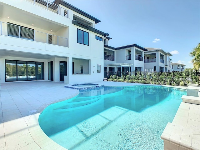 view of pool with an in ground hot tub and a patio area