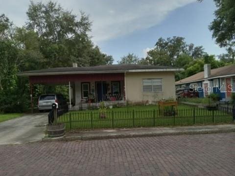 view of front of house with a front yard and a carport