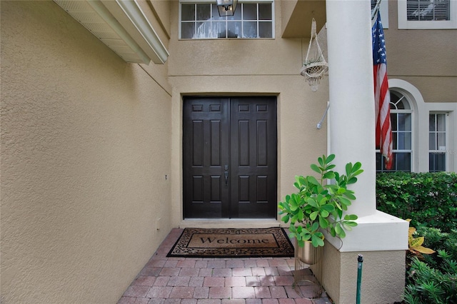 entrance to property featuring stucco siding