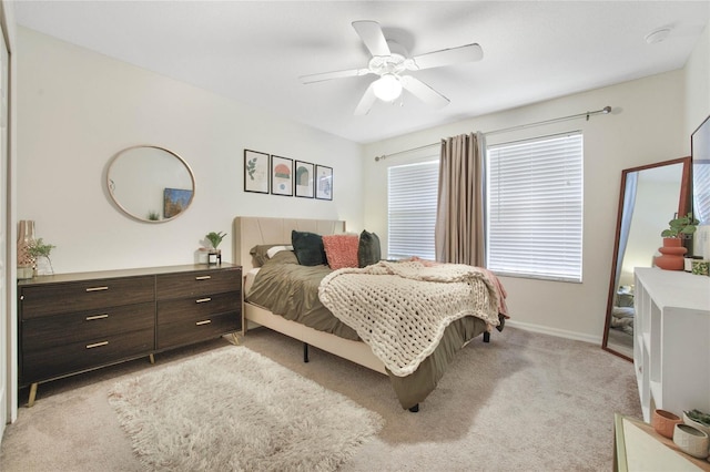 bedroom featuring light colored carpet and ceiling fan