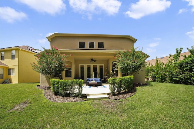 rear view of house featuring outdoor lounge area, a patio area, a lawn, and ceiling fan