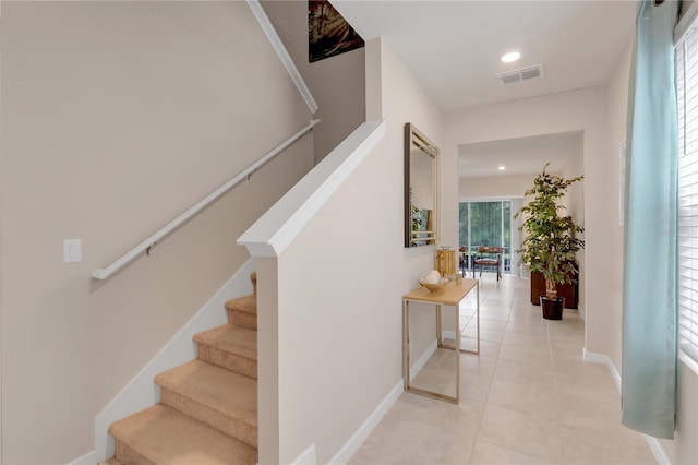 staircase featuring tile patterned floors