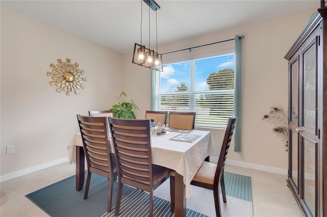 dining area featuring an inviting chandelier and light tile patterned flooring