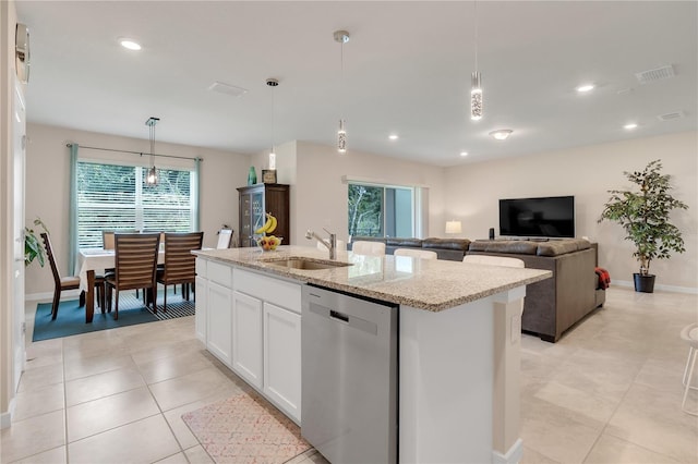 kitchen featuring white cabinetry, a kitchen island with sink, dishwasher, and sink