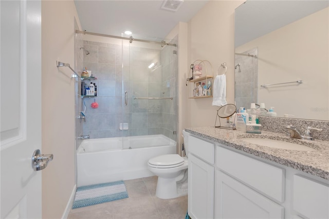 full bathroom with toilet, vanity, bath / shower combo with glass door, and tile patterned flooring