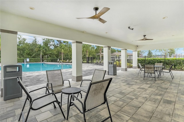 view of patio with ceiling fan and a fenced in pool