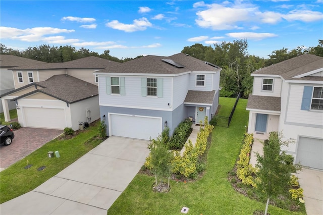 1001 Rivers Crossing St, Clermont, FL 34714 - traditional home with a shingled roof, driveway, roof mounted solar panels, stucco siding, and an attached garage
