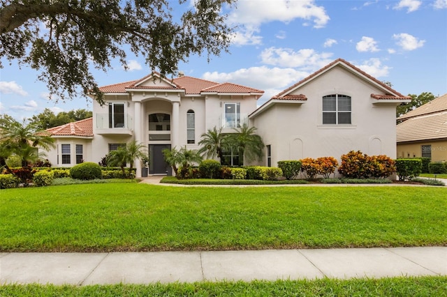 mediterranean / spanish house with a front yard