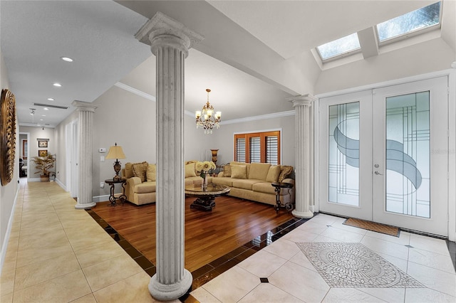 entrance foyer with french doors, an inviting chandelier, light wood-type flooring, and a wealth of natural light