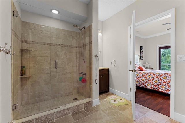 bathroom with ornamental molding, wood-type flooring, a shower with shower door, and vanity