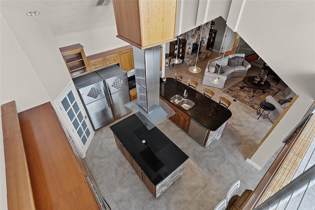 kitchen with a textured ceiling and light tile patterned floors