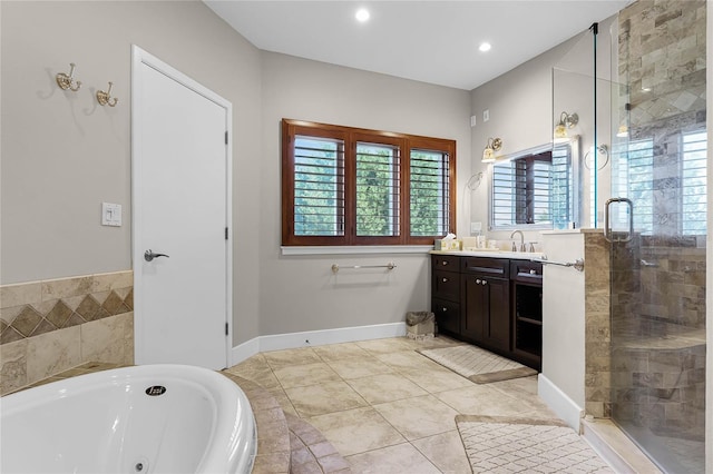 bathroom with tile patterned floors, independent shower and bath, and vanity