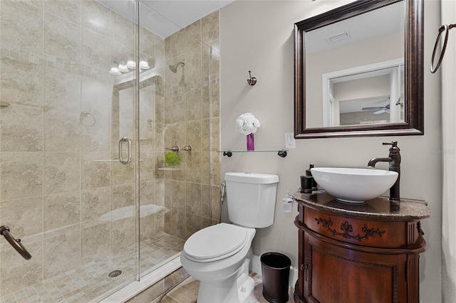 bathroom featuring vanity, toilet, and a shower with shower door