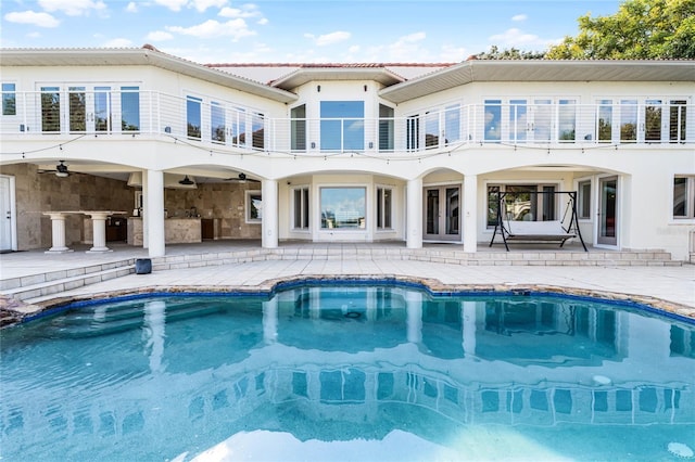 rear view of property with a balcony and a patio