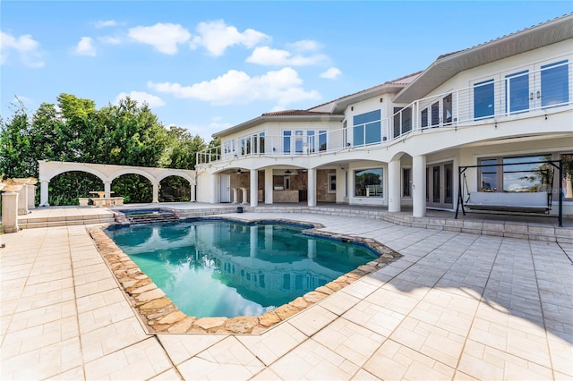 view of swimming pool featuring a patio and an in ground hot tub