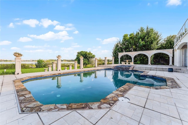 view of swimming pool featuring an in ground hot tub and a patio